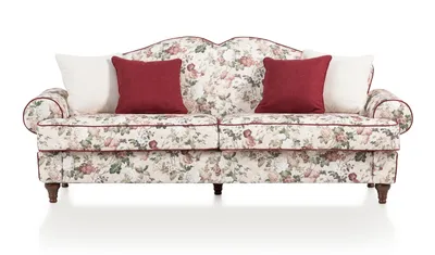 A floral patterned sofa with two red and two white throw pillows, presented against a white background.