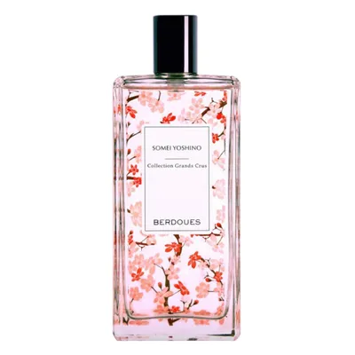 A bottle of perfume with a floral design.
