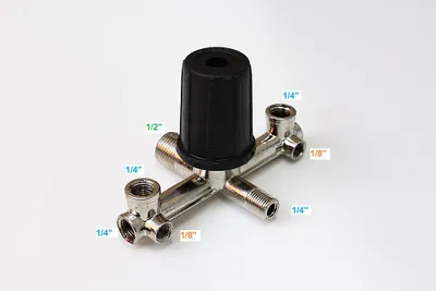 A metal pressure regulator with a black cap, with measurement labels pointing to different ports.