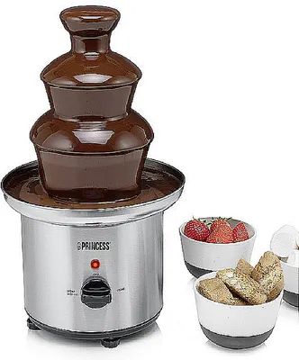 A chocolate fountain with bowls of strawberries and cookies.