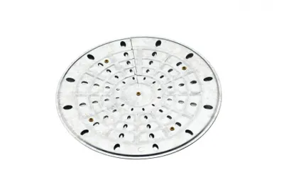 A circular metal heat diffuser with multiple holes and concentric rings, shown from a top-down perspective against a white background.