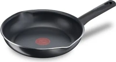 A black frying pan with a silver rim and a red logo in the center of the pan, set against a white background.