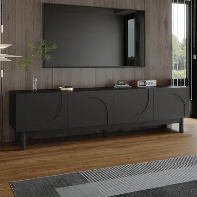 A modern living room with a black TV stand and a large television mounted on a wood-paneled wall.