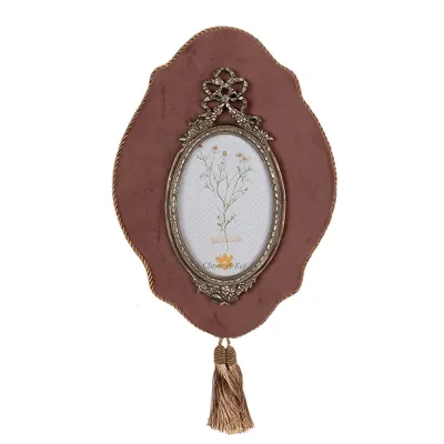 A decorative oval photo frame with a floral illustration inside, set against a plain white background.