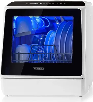 A white countertop dishwasher with a glass door, showing dishes inside illuminated by blue light.