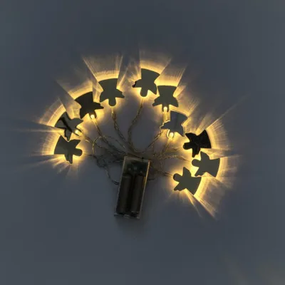 A string of fairy lights shaped like angels, powered by batteries.