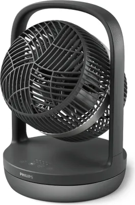 A black Philips desk fan is shown in a studio setting.