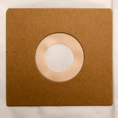 A close-up view of a vacuum cleaner bag with a circular opening for attachment.