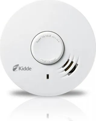 A white smoke detector is shown from a top-down perspective against a white background.