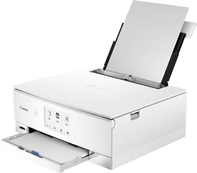 A white Canon PIXMA TS8351a 3-in-1 inkjet multifunction printer is shown from a front-side angle against a white background. Paper is loaded in the top feeder and partially in the output tray.