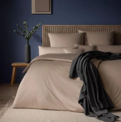 A bedroom scene with a neatly made bed.