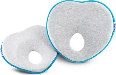 Two heart-shaped baby pillows with a hole in the center, placed on a white background.