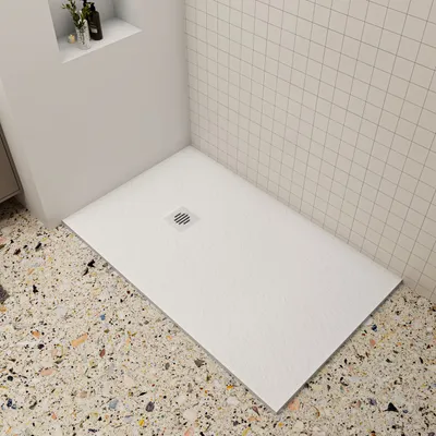 A modern bathroom corner with a white shower tray and tiled walls.