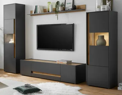 A modern living room setup featuring a wall-mounted TV and modular furniture.
