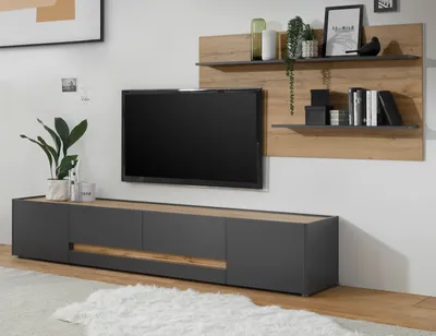 A modern living room entertainment center with a wall-mounted TV and shelving unit.
