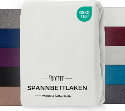 A folded white fitted sheet with a label and a certification logo.