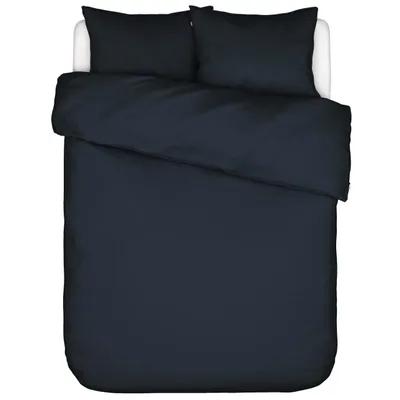 A top-down view of a dark blue duvet and pillow set on a white bed.