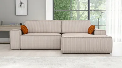A modern living room with a sectional sofa, large window, and artwork.