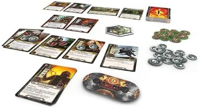 A collection of cards and tokens for a board game, laid out on a white surface.