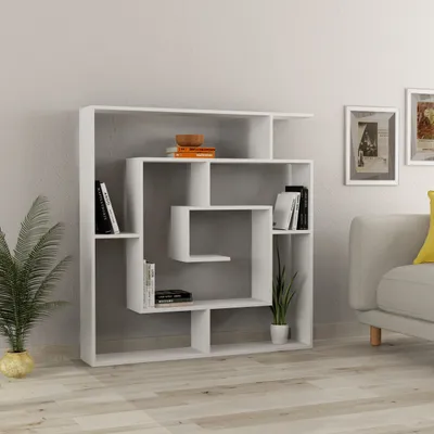 A white, modern bookshelf with books and plants placed on it, shown in a room setting with a sofa and framed art on the wall.