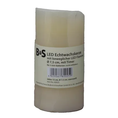 A cream-colored LED candle with a label wrapped around it.