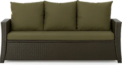 A front view of a brown rattan sofa with green cushions.