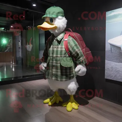 Produktbild von Maskottchen REDBROKOLY Kostümfigur der grünen Flugente bekleidet mit einem Flanellhemd und Messenger-Taschen