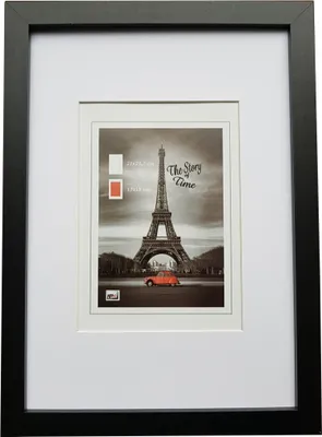 A framed picture of the Eiffel Tower with a red car in front.