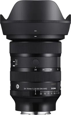 A close-up studio shot of a black camera lens with its lens hood attached.
