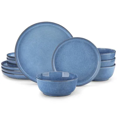 A set of blue ceramic plates and bowls stacked and arranged on a white background.