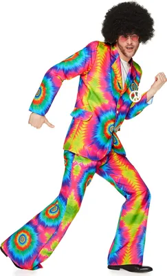 A man wearing a colorful tie-dye hippie costume, including a jacket and flared pants, is posing dynamically against a white background.