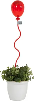 A red balloon LED light on a decorative plant in a white pot.