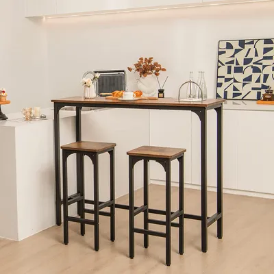 A bar table and two bar stools are set up in a modern kitchen or dining area.