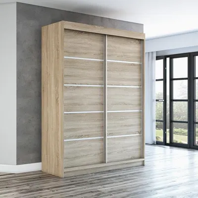 A wooden wardrobe with sliding doors in a room with a gray wall and wooden floor.
