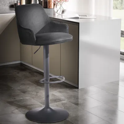 A dark gray bar stool is shown in a modern kitchen setting, next to a white counter.