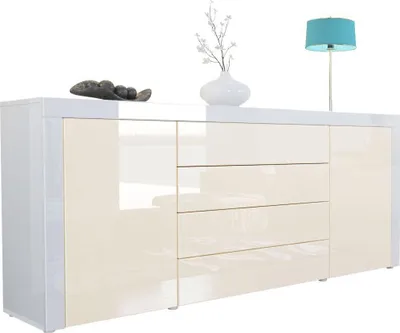 A white and cream high-gloss sideboard with decorative items on top.