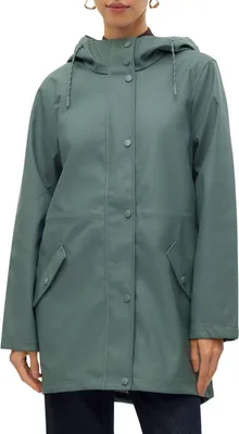 A woman wearing a green jacket.