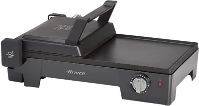 A dark gray electric grill with a flat plate on the right and a hinged lid on the left. The lid is partially open, revealing the interior. A dial and a red indicator light are visible on the front right side of the base.