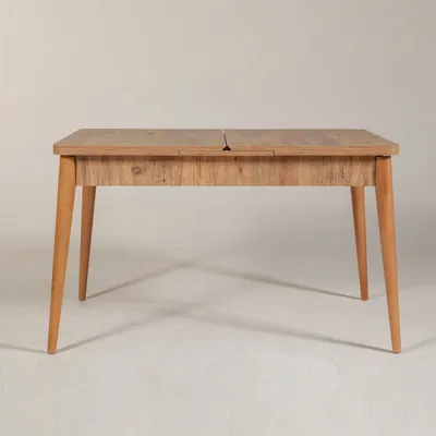 A wooden dining table with four legs against a white background.