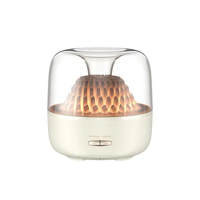 A white aroma diffuser with a clear glass top and a honeycomb-like structure inside that is illuminated.