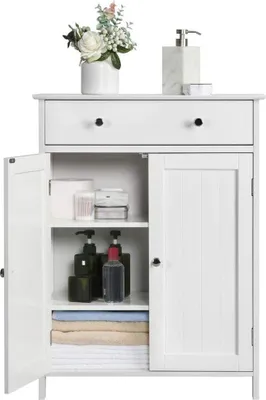 A white bathroom cabinet with a drawer and two doors is shown. The cabinet is open, revealing shelves with bath products and towels.