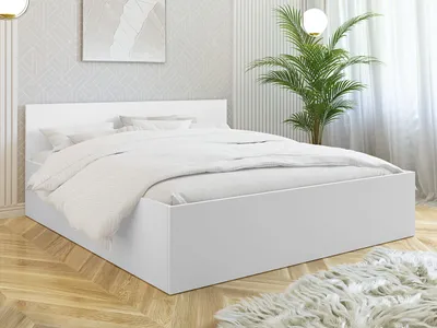A white bed frame with white bedding in a well-lit bedroom.