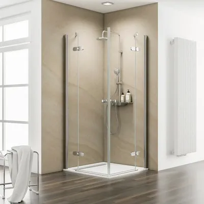 A modern bathroom with a glass shower enclosure and a white radiator.