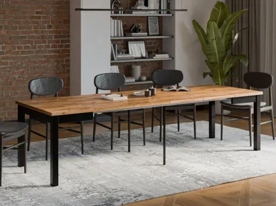 A dining room scene with a wooden extendable table and chairs.
