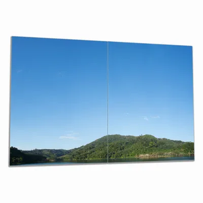 Produktbild von Wallario Herdabdeckplatte aus Glas, Größe 80 x 52 cm 2-teilig, Motiv Grüne Hügel am Wasser