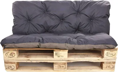 A dark gray cushion set on a wooden pallet.