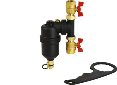 A magnetic sludge separator with brass fittings and red valve handles, along with a black wrench, is displayed against a white background.
