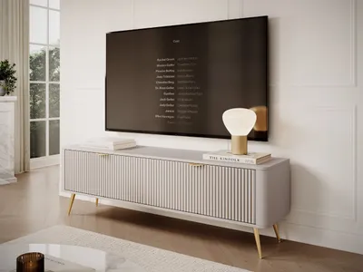 A modern living room scene with a TV stand, television, and lamp.