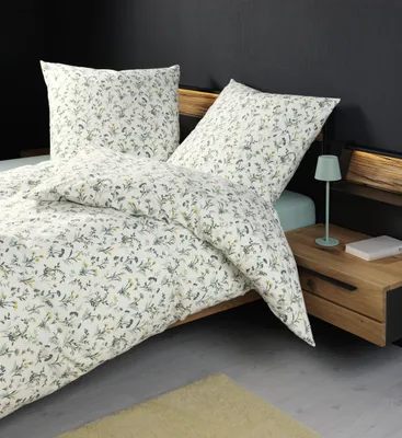 A close-up view of a bed with floral patterned bedding.