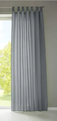 A gray curtain hanging in front of a window.
